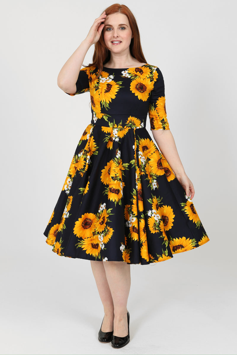 day dress in lemon yellow cotton with stylized sunflower print Vintage Summer Sunflower Print Sleeveless Maxi Dress with Hatler Neck and boho swing Detail